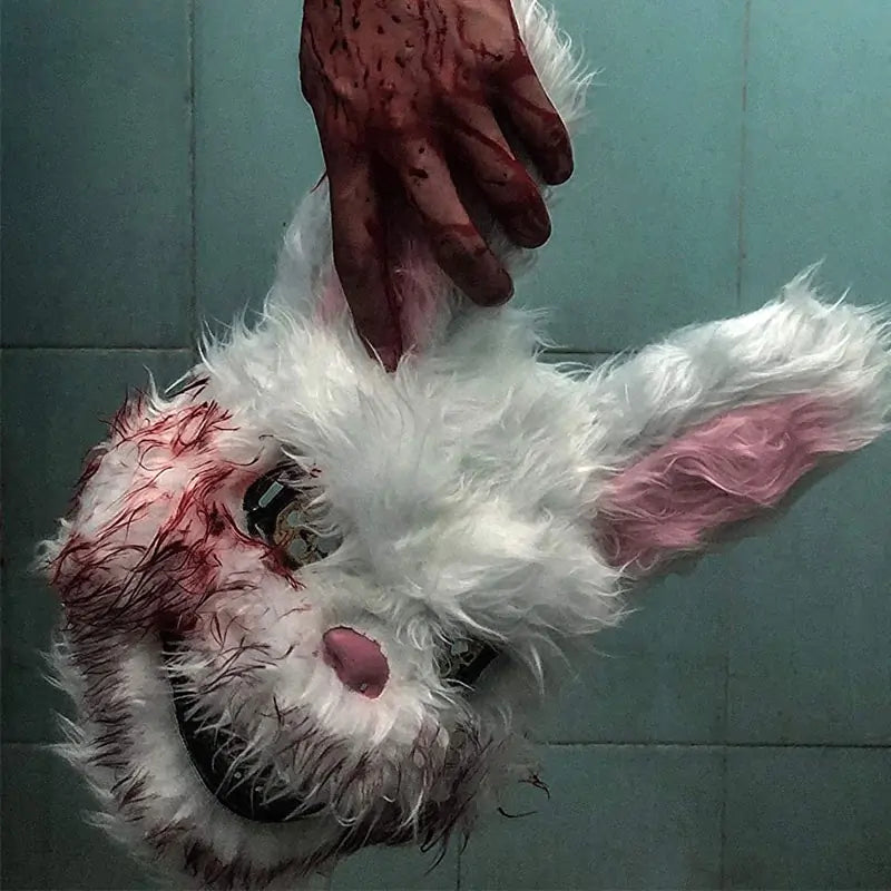 holding a bloody rabbit head